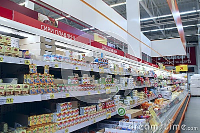 Wide range of processed cheese on shelves of supermarket. Choice of milky goods Editorial Stock Photo