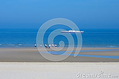 Wide sandy beach near the North Sea. Beautiful promenade of Ostend in the early morning. An amusing Editorial Stock Photo