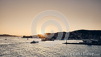 Wide shot of boats on the water with buildings on the hill in the distance Stock Photo