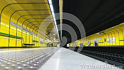 Wide shot of the interior of a subway station with yellow walls Editorial Stock Photo