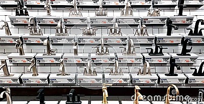 Wide shot of multiple bathroom sink faucets in an aisle at a Lowe`s home improvement store. Editorial Stock Photo
