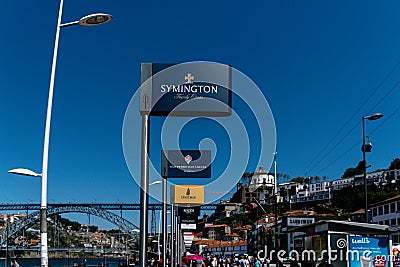 Wide shot of signs of various port wine brands in downtown douro river, Portugal Editorial Stock Photo