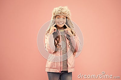 Wide sincere smile. Warm hat for cold weather. Faux fur trend. Girl long curly hair wear fur hat with ear flaps pink Stock Photo