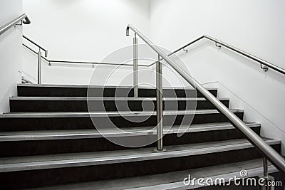 Wide staircase with chrome handrails Stock Photo