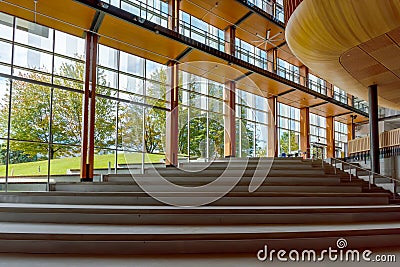 A wide staircase in the interior of a modern building with large Stock Photo