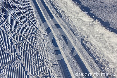 a wide track for ski competitions with many traces from skis skating and classic skiing as real natural background Stock Photo
