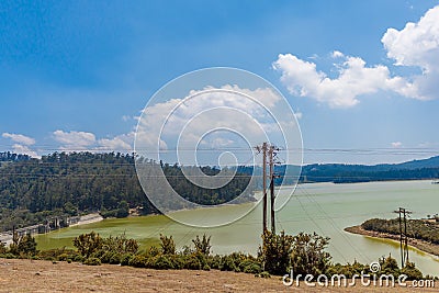 Wide view of emerald lake with beautiful sky, tress in the background, Ooty, India, 19 Aug 2016 Stock Photo