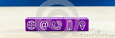 Wide view image of customer service with five purple wooden dices with contact information and location icons on them Stock Photo