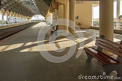 Wide view of a locomotive electric train station platform with unoccupied seat and covered tunnel, Chennai, India, Mar 29 2017 Editorial Stock Photo