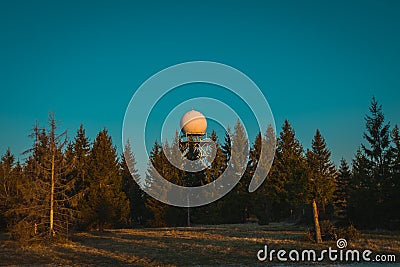 Wide view of a rain radar or meteorological doppler radar for measuring precipitation in early morning hours during sunrise on Stock Photo