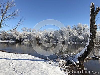 Shoeprints in the snow by the pond on a cold day in winter Stock Photo