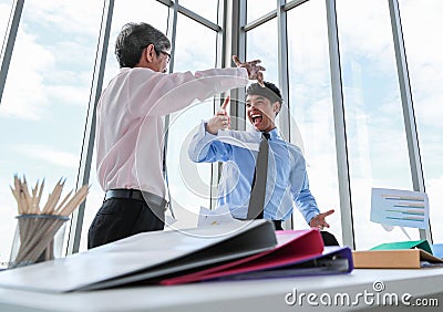Wide view shot of two Asian businessmen looking at each other eyes with a pleasant smiling and shaking hands. The senior and young Stock Photo