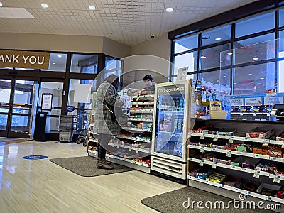 Lynnwood, WA USA - circa November 2022: Wide view of a woman checking out at the counter of a Rite Aid Pharmacy Editorial Stock Photo