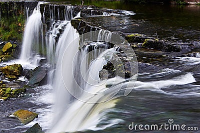 Wide waterfall in summer time Stock Photo