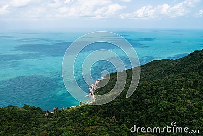 Wiew of a beautiful sea shore with a beach and green rainforest Stock Photo