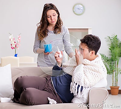 Wife caring for sick husband at home Stock Photo