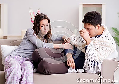 Wife caring for sick husband at home Stock Photo