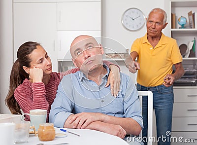 Wife comforting husband after a family conflict Stock Photo