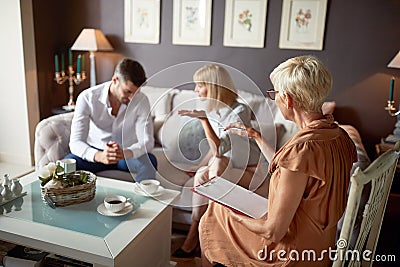 Wife in discussion with husband at psychologist Stock Photo