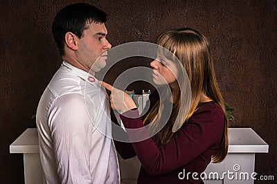 Wife finded red lipstick on shirt collar - infidelity concept Stock Photo