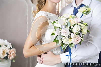 The wife of the husband embraces a wedding bouquet. Newlyweds. Wedding day Stock Photo