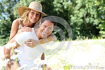 Wife on husband's back Stock Photo