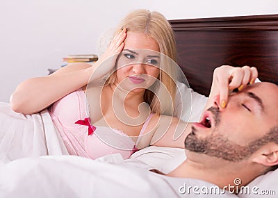 Wife with husband snoring in sleep Stock Photo