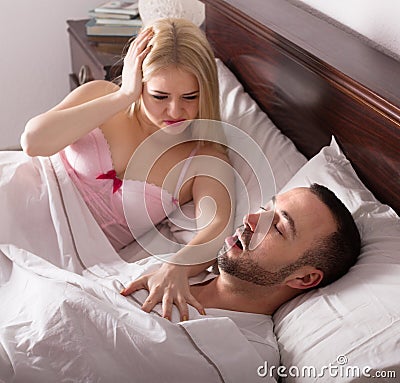 Wife with husband snoring in sleep Stock Photo