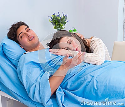 Wife visiting ill husband in the hospital room Stock Photo