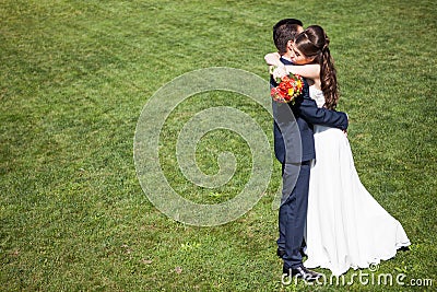 Wife in wedding dress embrancing the husband Stock Photo