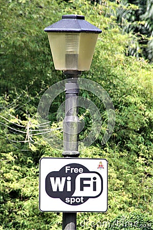 WiFi free spot lamp pole in park Editorial Stock Photo