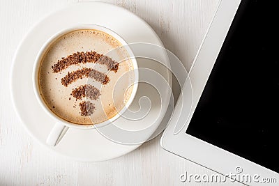 WiFi symbol made of cinnamon powder as coffee decoration on cup of cappuccino. Stock Photo