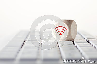 Wifi symbol on wooden cube on computer keyboard. Wi-fi connection with computer, distant learning or online education concept Stock Photo