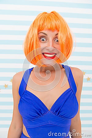 Wig bright artificial hair looks unnatural. Hair revival procedure advice. Cosmetics for care and revival. Lady red Stock Photo