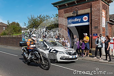 WIGAN, UK 14 SEPTEMBER 2019: A photograph documenting the Vittoria support vehicle and a race support motorcycle as part of the Editorial Stock Photo