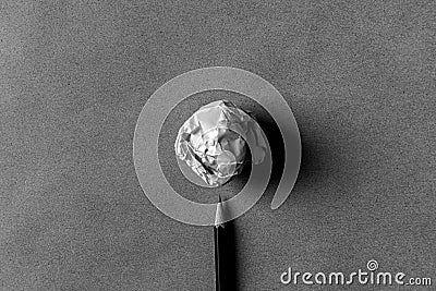 A wihte paper ball and black pencil on brown paper. Stock Photo