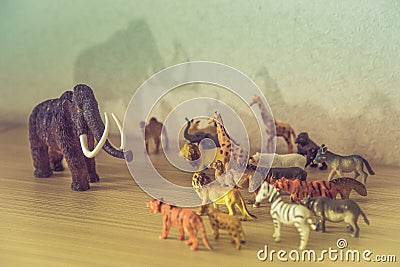 Wild animals against a huge prehistoric mammoth Stock Photo
