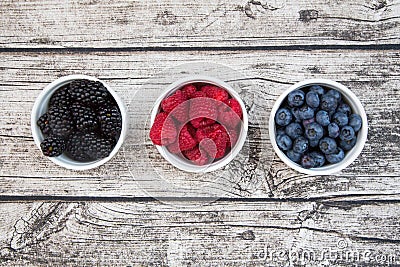 Wild berries, Raspberries, blueberries and blackberries in bowls Stock Photo