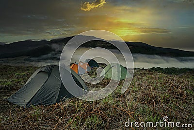 Wild Camping in the Scottish Mountains above the clouds at sunset Stock Photo