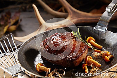 Wild deer venison steak with autumn mushrooms Stock Photo