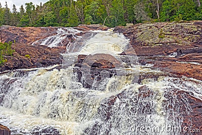 Wild River Tumbling Across Ancient Rocks Stock Photo