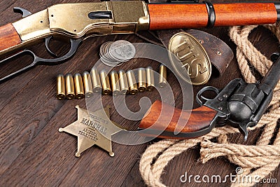 Wild west guns, ammunition and marshal badge with silver dollars Stock Photo