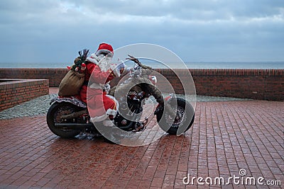 Wilhelmshaven, Germany - December 24: Unidentified biker dresses as Santa Claus for Christmas at the South Beach on Editorial Stock Photo