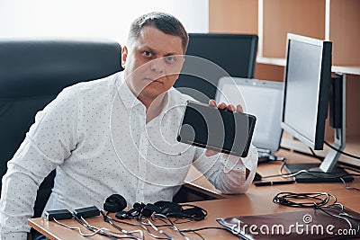 We will expose your dishonesty by this thing. Polygraph examiner works in the office with his lie detector equipment Stock Photo