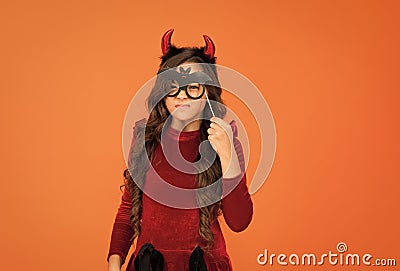 will terrify you. child celebrate autumn holiday. teenage girl in devil horns celebrate halloween. happy halloween Stock Photo