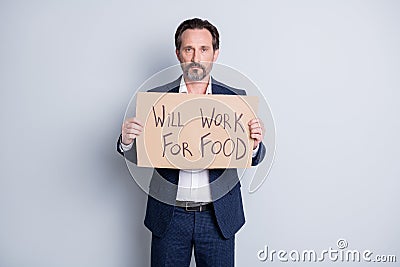 Will work for food. Photo of serious sad poor worker dismissed guy suffer financial crisis lost work hold placard search Stock Photo