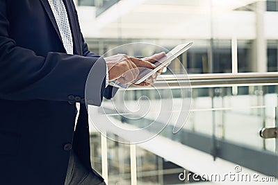 This will work out not to be too expensive. a unrecognisable male businessman using a digital tablet inside of a Stock Photo