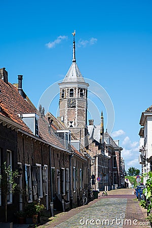 Willemstad, North Brabant, The Netherlands - Catholic church tower at the center of the village against blue sky Editorial Stock Photo