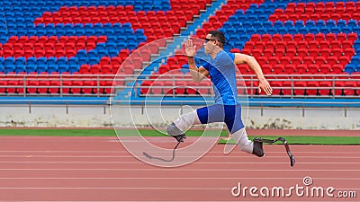 Willful Asian athlete speeds up on stadium track, aiming to break his record with prosthetic blades Stock Photo