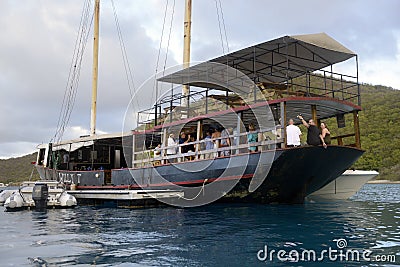 The William Thornton Floating Bar & Restaurant schooner, an old steel ship about 100 feet long, The Bight, Norman Island, BVI Editorial Stock Photo